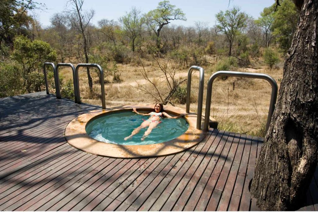 Inground plunge pool with girl swimming on patio