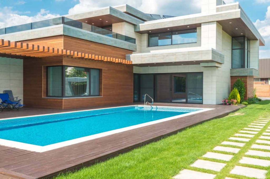 A custom lap pool that is long in shape and perfectly fitted into the landscape of a modern house in Brisbane