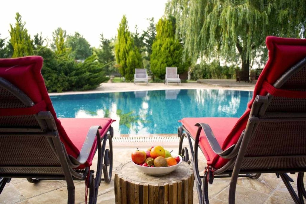 A plunge pool with a pink chair for lounging