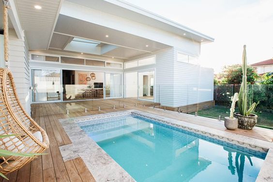 Rectangle plunge pool in the backyard, seamlessly connected to the indoor space through large glass doors, offering an open and airy outdoor experience.