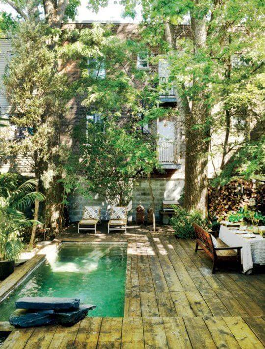 Rectangle plunge pool exuding rustic charm, complemented by distressed wooden furniture for a warm and inviting outdoor retreat.