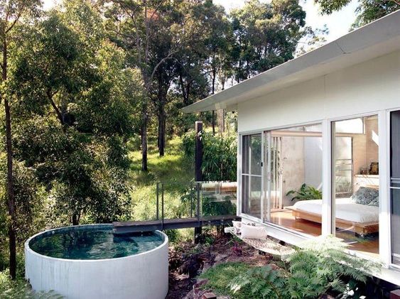 Round plunge pool set against a natural backdrop, offering a serene spot to enjoy and appreciate the beauty of nature while dipping.