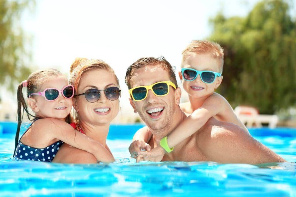 family with mom, dad, daughter and son plunging in precast plunge pool