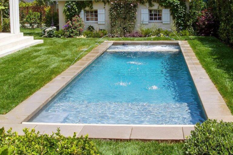 Rectangle concrete pool in brisbane in green backyard with flowers