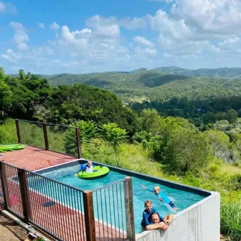Above ground plunge pool with raised structure and hillside views in Holland Park Brisbane