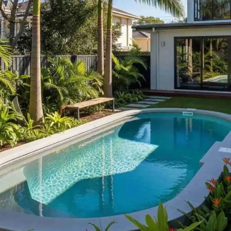 Custom concrete plunge pool with curved edges and landscaped backyard in Camp Hill