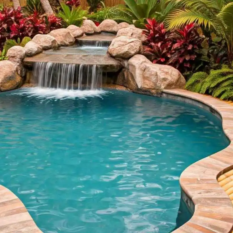 Freeform pool with natural rock waterfall feature and curved edges in Chelmer garden