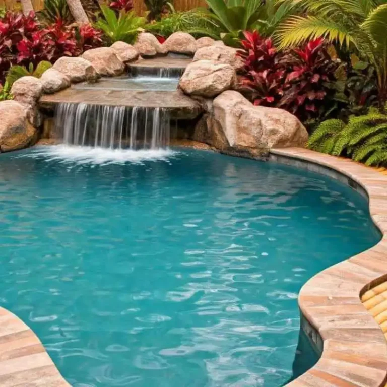 Freeform pool with rock waterfall feature and natural landscaping in Holland Park garden