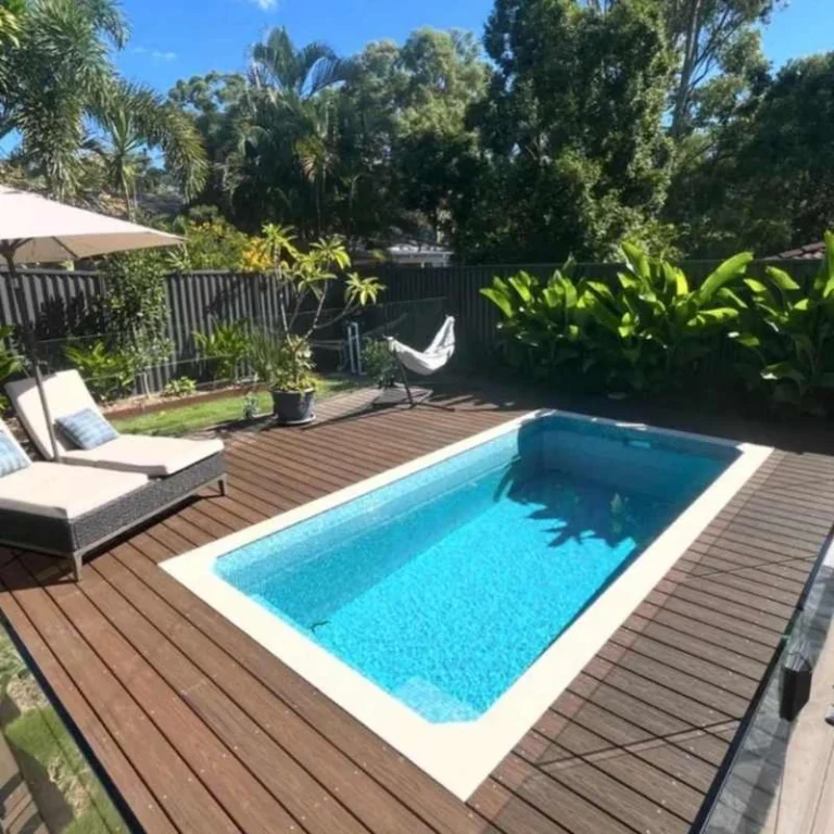 Precast concrete plunge pool with timber decking and compact layout in Calamvale