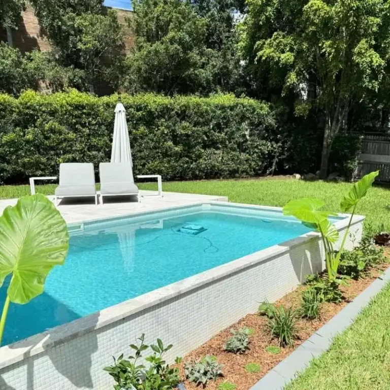 Semi above ground plunge pool with tiled finish and garden landscaping in Calamvale backyard